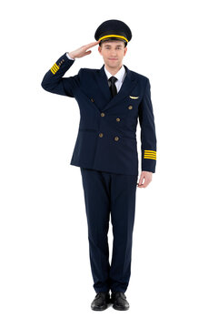 Handsome airline pilot in work uniform standing and saluting isolated on white background