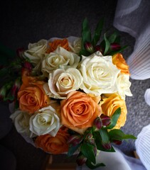 A wonderful wedding bouquet of white and orange roses.