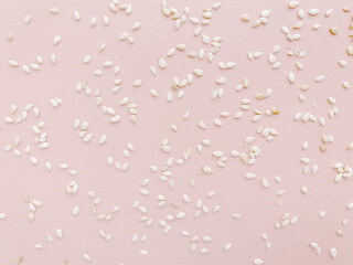 Pattern of white sesame seeds, pink delicate background