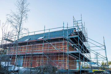 Close up view building under construction on blue sky background. Industry concept. Sweden.