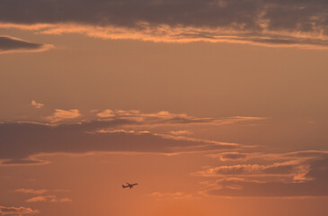 Fototapeta na wymiar Beautiful sunset sky and silhouette of aircraft