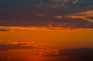 Beautiful orange sunset sky and silhouette of aircraft