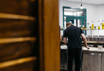 Man preparing pizza in a pizzeria