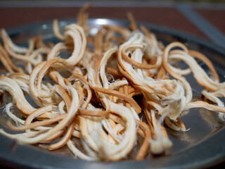 smoked pigtail cheese on a plate. beer appetizer