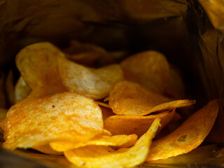 chips inside the bag. delicious slices of potatoes fried in butter. junk food.