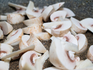 sliced raw mushrooms in a frying pan. cooking dinner.