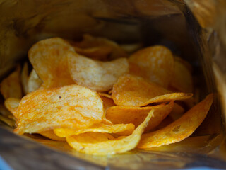 delicious chips inside the bag. delicious slices of potatoes fried in butter. junk food.