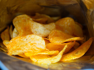 delicious chips inside the bag. potatoes fried in oil. junk food.