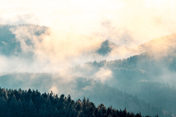 Clouds in mountains in winter during sunset