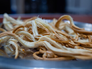 pigtail smoked cheese on a plate. delicious beer snack