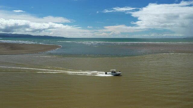 Zancudo aerial shot following a boat mouth river pacific ocean Costa Rica