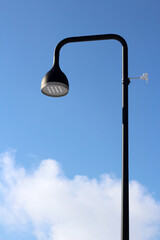 Solar powered electric city lantern on blue sky