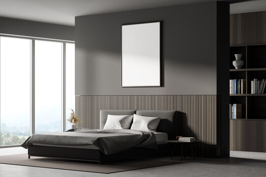 View of a bedroom with king size bed, a bookshelf, a panoramic window. Large vertical poster is hanging above the bed. 3d rendering. Mock up.