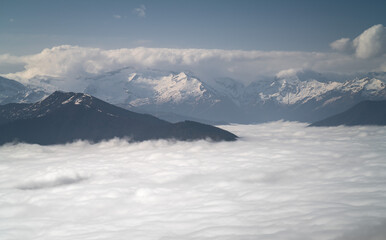 Fototapeta na wymiar Mountain Range Emerging From The Clouds