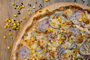 Pizza with onions, ham and corn
