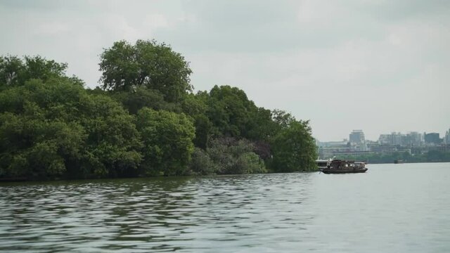 Touristic boats and Hangzhou city seen from the West Lake China