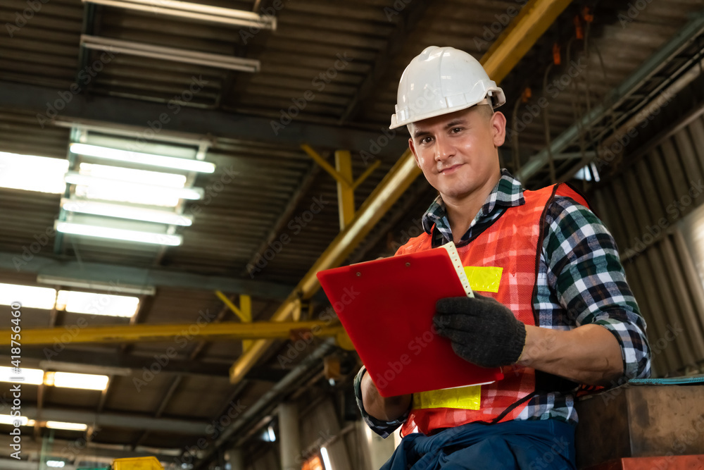 Poster manufacturing worker working with clipboard to do job procedure checklist . factory production line 