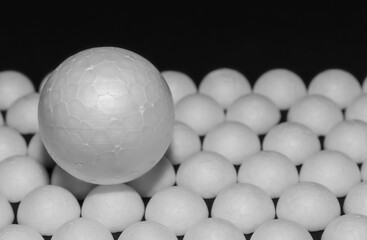a white ball located on the white hemispheres. Black background.