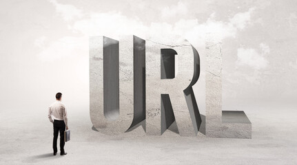 Rear view of a businessman standing in front of URL abbreviation, attention making concept