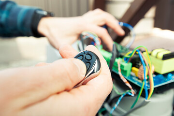 Technician man installing and checking the function of automatic gate