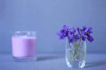 Small violet bouquet in a little glass. Nobody
