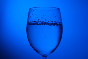 clean water in a glass drop glass in cold tone