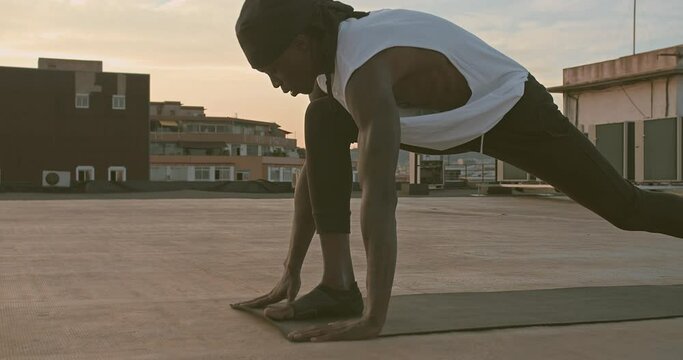 Black Muscular Male Athlete with Fit Body Practicing Pilates Training on Mat Outside. Well-being, Lifestyle, Healthcare Concept.