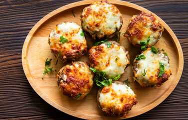 Puff basket with mushrooms in creamy sauce and cheese on wooden background