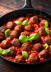 Vegetarian spaghetti with meat free, vegan meatballs in rich tomato sauce in iron cast pan