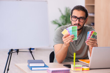 Young male designer working in the office