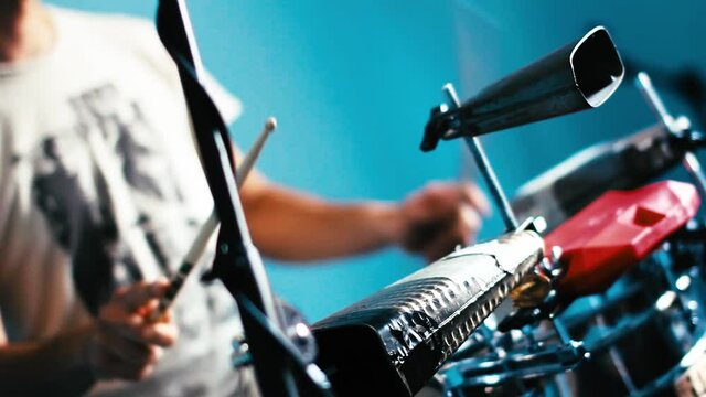 Drummer recording cuban music in a studio.
Close-up of playing cuban Salsa on drums. Cowbell, Jam Block, drumkits and rhythm.