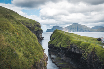 Faroe islands village of Gjogv or Gjov in Danish. Sea-filled gorge on the northeast tip of the island of Eysturoy, in the Faroe Islands.