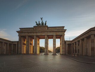 Brandenburg Gate in Berlin, Germany with sunlight shining through during Sunset.