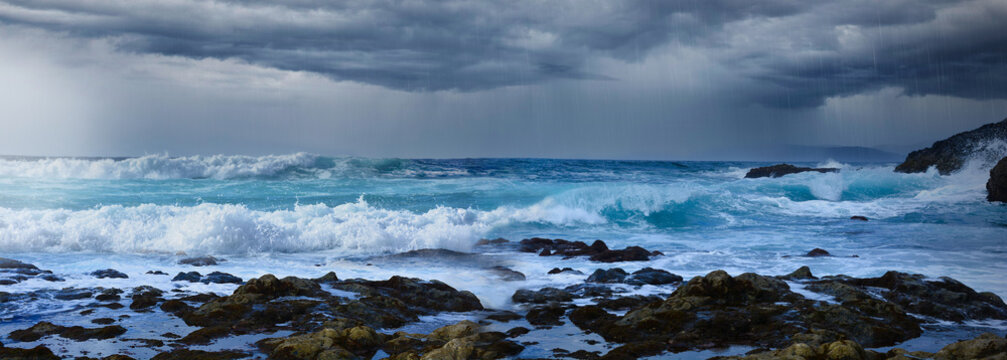 Sea coast with dark rain thunder clouds and stormy sea.