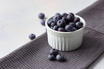 Blueberries in the bowl on the towel