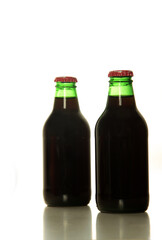 two bottles of pomegranate juice isolated on white background