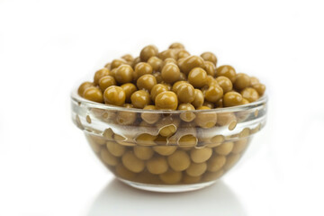canned peas in a clear bowl on a white background