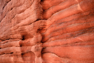Color structure, texture of sandstone rocks of Petra, color shades of orange and red, visible layers of sandstone, Jordan