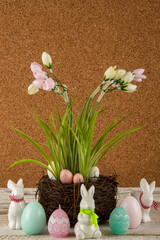 A bouquet of flowers with Easter eggs and Easter bunnies on a brown background.