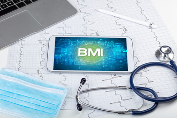 Close-up view of a tablet pc with BMI abbreviation, medical concept