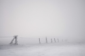 Snow covered signposts on the mountainside.