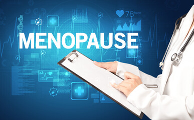 young doctor writing down notes with MENOPAUSE inscription, healthcare concept