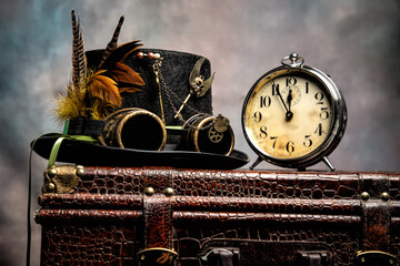 Steampunk Hat on Top of Suitcase with Vintage Alarm Clock