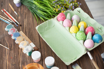 Table with paint and brush for painting easter eggs
