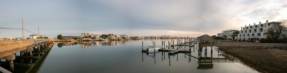 Fototapeta premium Panoramic view of the Banks Channel in Wrightsville Beach, from the River To The Sea Bikeway Bridge, to floating docks and condos on the west side of the sound.