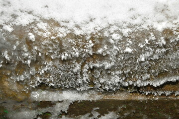 frost on the wooden wall near the font
