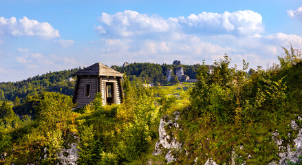 Fototapeta na wymiar Panoramic view of medieval Ogrodzieniec Castle seen from Gora Birow Mountain royal stronghold in Podzamcze of Silesia region of Poland