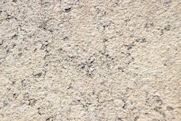 beige stone texture with dark spots close up