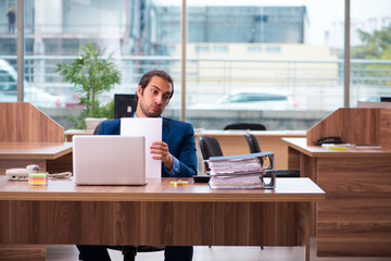 Young male employee working in the office