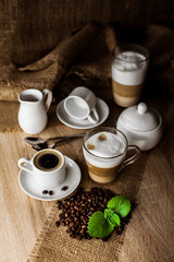 Coffee beans, mint, espresso, cappuccino, latte on the table